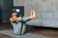 woman goes in for sports in virtual reality using VR glasses(Image via Getty Images)